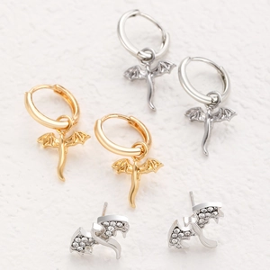 Detailed macro view of winged dragon earrings with sparkling crystal accents