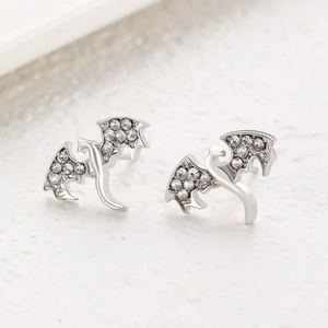 Detail view of silver dragon stud earrings with sparkling white cubic zirconia stones