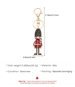 Detailed macro view of the rhinestone-studded British Royal Guard soldier pendant and size specs