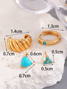 Detail of 14K gold turquoise earring set including hoop, ear cuff, and heart studs