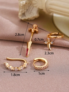 Detailed view of 14K gold-plated earring set with cubic zirconia and red gem sword charms