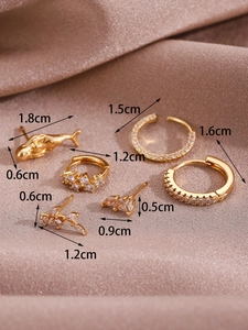 Detailed view of 14K gold hoop earrings set with micro-pave zircons on silk fabric