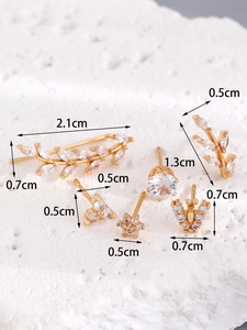 Macro shot of 14K gold-plated earring set with zircon leaf and stud details