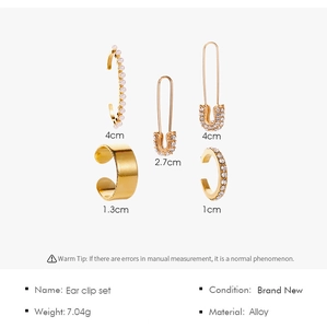 Detailed view of gold ear clip set with pearls and rhinestones, weights and sizes included