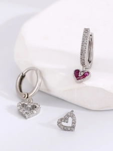 Macro shot of 14K gold-plated heart hoop earrings set with sparkling zircon stones