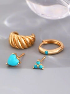 Detail view of 14K gold plated earring set featuring turquoise heart and hoop designs