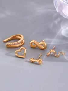 Detailed view of 5-piece 14K gold-plated earring set with cubic zirconia on matte surface