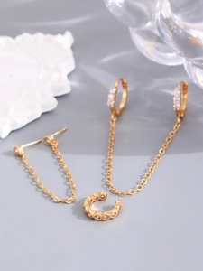 Detailed view of 14K gold-plated chain earrings and ear cuff with white cubic zirconia