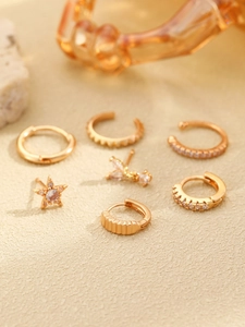 Detailed view of 7pcs 14K gold plated hoop earrings and zircon studs set on sand stone