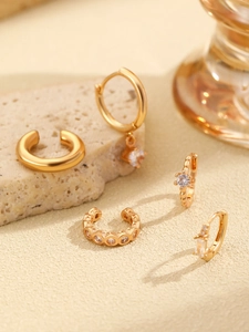 Detailed set of 14K gold hoop earrings and ear cuffs with micro-pave cubic zirconia