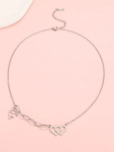Detail of silver interlocking hearts and S-shaped geometric pendant on stainless steel chain
