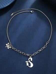 Detail of mixed chain necklace featuring swan and dragonfly charms with K18 engraving