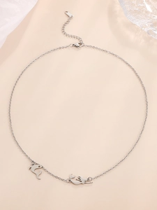 Polished stainless steel necklace featuring detailed dolphin and mermaid charms on a fine chain