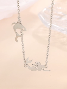 Macro view of silver stainless steel O-chain necklace with dolphin and mermaid pendants