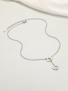 Macro view of stainless steel heart and star pendant necklace with K18 engraving detail