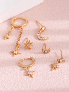 Close-up of 14K gold plated earring set with moon and star pendants and pavé zircon stones