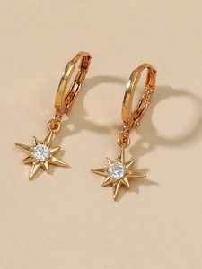Close-up of 14K gold hoop earrings with micro-set zircon star-shaped pendants