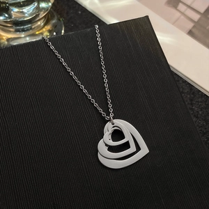 Detail of silver triple-layered hollow heart pendant on high-quality stainless steel chain