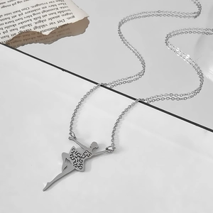Detail of a ballerina pendant necklace featuring an intricate cutout skirt design
