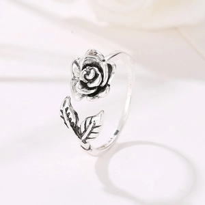 Macro shot of vintage silver S925 rose flower ring with detailed leaves and open band