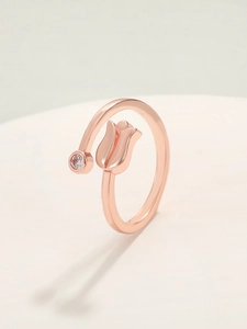Detailed macro view of rose gold tulip ring with a sparkling round zircon stone