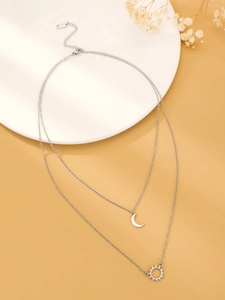 Close-up of double layer sun and moon pendant necklace with S.STEEL material engraving