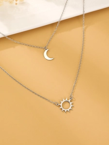 Detailed view of silver double-layer necklace with celestial sun and moon pendants