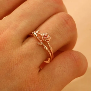 Elegant rose gold flower ring with intricate blooming rose and leaf design in an open style