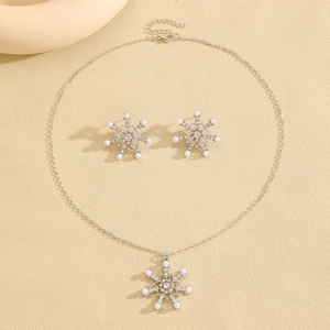 Detail of snowflake jewelry set with elegant pearls and sparkling rhinestones on necklace