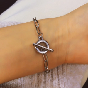 Minimalist silver chain bracelet with OT toggle clasp on wrist with knitted background