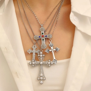 Detail of four-piece cross necklace set with colorful rhinestones and white pearls