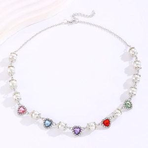 Detail of beaded necklace with colorful heart gems, faux pearls and silver adjustable chain