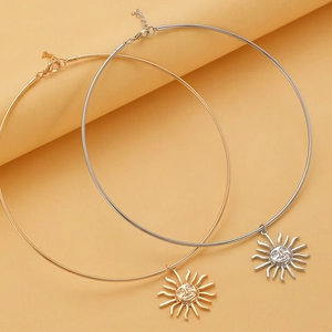 Detail of sun pendant chokers in gold and silver finish with adjustable lobster clasp