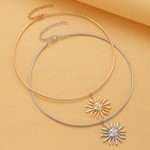 Detailed view of gold and silver choker necklaces with sun god face relief pendants