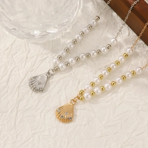 Detail of French vintage shell pendant necklace with pearls and sparkling rhinestones