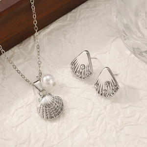 French vintage shell pendant jewelry set with pearls and rhinestones on white background