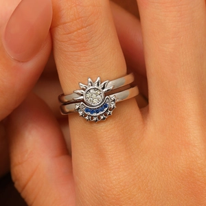 Macro shot of sun and moon couple ring set featuring blue and white zircon inlay