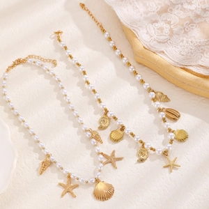 Bohemian pearl necklace with gold starfish and seashell charms for beach vacations