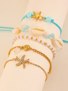Detail of five-piece ocean charm bracelets set with starfish and seashell ornaments