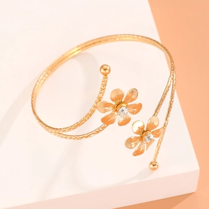 Bracelet de bras fleuri doré avec cristaux centraux et texture martelée élégante