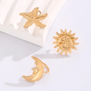 Golden starfish sun and moon clip earrings with vintage celestial textures and metallic finish