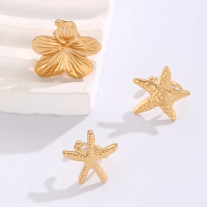 Golden alloy ear cuff set featuring textured starfish and floral designs on stone