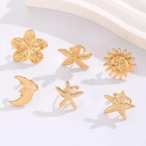 Detailed view of six gold alloy ear cuffs featuring starfish, moon, and sun motifs