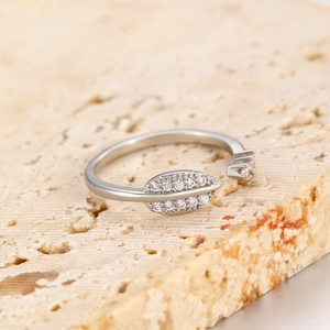 Macro detail of silver adjustable leaf ring with sparkling cubic zirconia on stone base