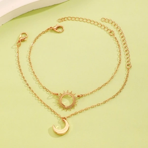Detail of gold sun and moon pendant necklace set with adjustable lobster clasp links