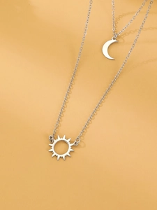 Detail of silver double-layer necklace featuring bohemian sun and crescent moon pendants