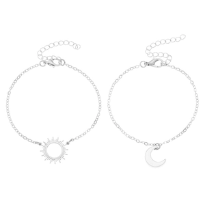 Detail of silver sun and moon pendant bracelets with fine cable chains and lobster clasps