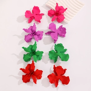 Macro detail of 3D geometric flower earrings with colorful matte lacquer finishes