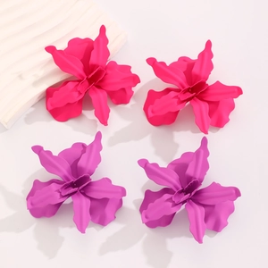 Detail of large 3D matte flower earrings in hot pink and purple with wrinkled petals