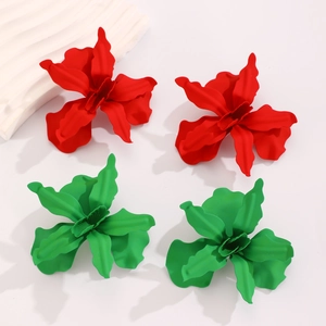 Detail of red and green matte floral earrings with dimensional wavy petal texture